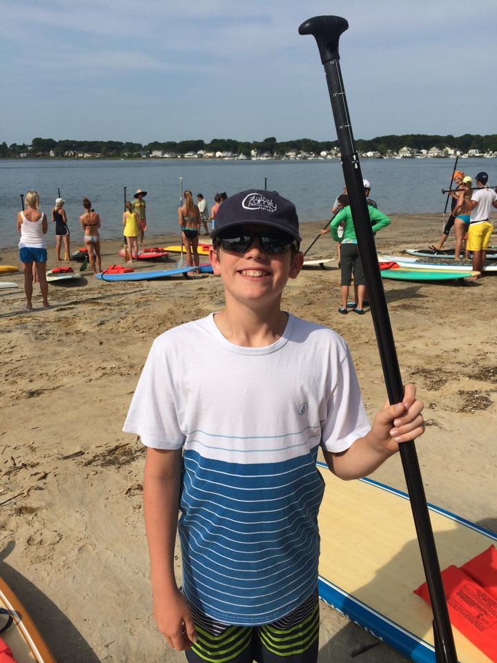 Moms Rock The River young boy with a paddle