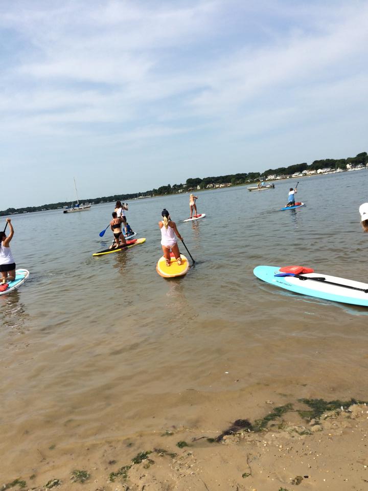 Moms Rock The River paddleboarders out on the water