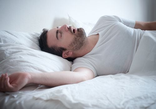 man sleeping in bed