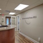 Front desk with logo behind it