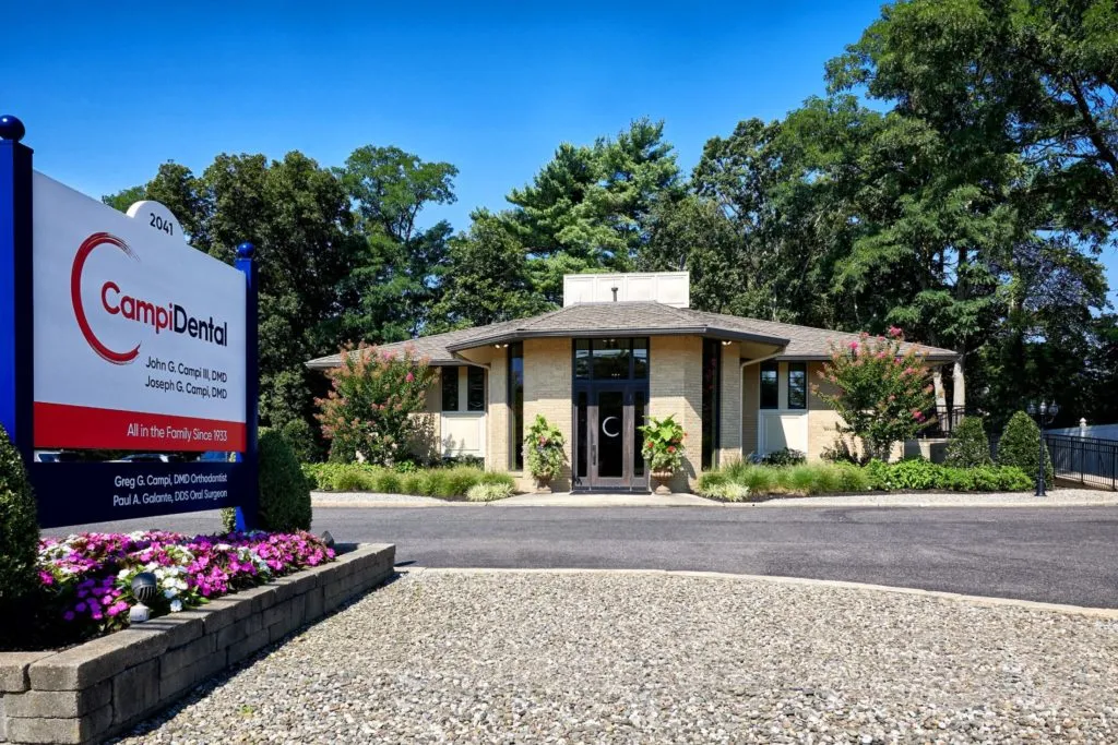 Campi Dental office sign with the building in the background